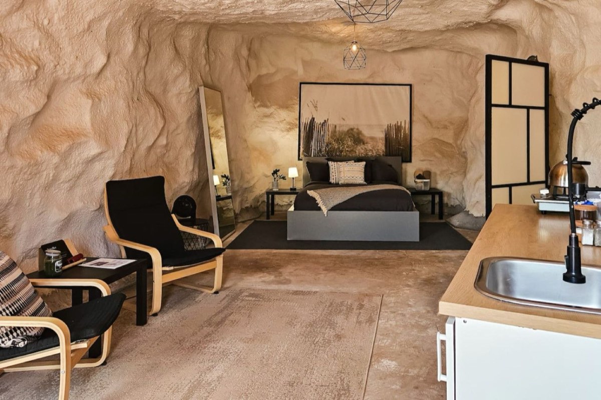 The interior of a cave chamber, with seating and a kitchenette